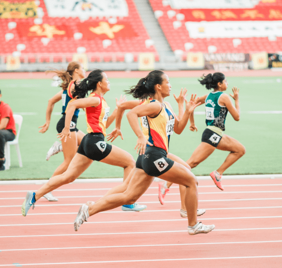 Women running on track demonstrating physical activity. Credit Jonathan Chng