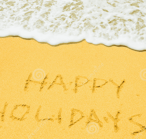 Happy holidays etched into sand at beach to wish everyone Merry Xmas
