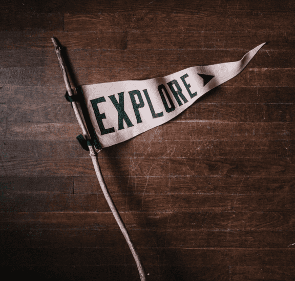 Old style flag which reads Explore. Photo credit: Andrew Neel